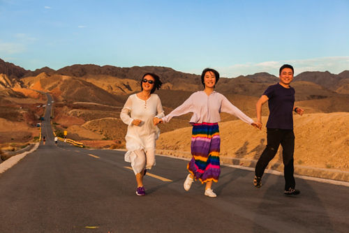 Yike with her family outside on a road